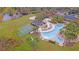 Aerial view of a community pool with a lake, playground, basketball and sand volleyball courts, and lounge area at 3734 Safflower Terrace, Oviedo, FL 32766