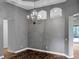 Elegant dining room with wood floors, gray walls, and a decorative chandelier at 3734 Safflower Terrace, Oviedo, FL 32766