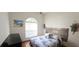 Bright bedroom with a blue-and-white quilt, wood headboard, and a window for natural light at 3887 Kingston Oaks Cv, Oviedo, FL 32765