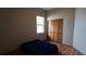 Bedroom with simple decor, featuring a window, a dark-blue bed, and a sliding-door closet at 3887 Kingston Oaks Cv, Oviedo, FL 32765