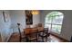 Formal dining room with a wood table and contemporary light fixture at 3887 Kingston Oaks Cv, Oviedo, FL 32765