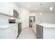 Bright kitchen featuring stainless steel appliances, white cabinets, and an island with a sink at 3922 Sw 130Th Loop, Ocala, FL 34473