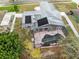 Aerial view of home featuring screened pool, solar panels and partially fenced backyard at 409 Surrey Run, Casselberry, FL 32707