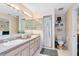 Bathroom featuring a double sink vanity with a large mirror, and shower at 409 Surrey Run, Casselberry, FL 32707