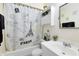 Cozy bathroom featuring a Paris-themed shower curtain and convenient above-toilet storage at 409 Surrey Run, Casselberry, FL 32707