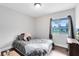 Cozy bedroom featuring a large window, plush bedding, and a wood floor at 409 Surrey Run, Casselberry, FL 32707