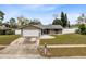 Charming single-story home with well-manicured lawn, attached garage and inviting entrance at 409 Surrey Run, Casselberry, FL 32707