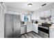 Functional kitchen with white cabinets, stainless steel appliances, and a window bringing in natural light at 409 Surrey Run, Casselberry, FL 32707