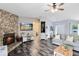 Bright living room featuring a stone fireplace, modern furnishings, and views into other areas of the home at 409 Surrey Run, Casselberry, FL 32707