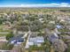 An elevated view captures a residential area with houses nestled among lush trees under a vast expanse of blue sky at 418 Norwood Ct, Oviedo, FL 32765