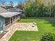 Aerial view of the backyard with the screened-in porch and patio with backyard seating at 418 Norwood Ct, Oviedo, FL 32765