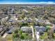 An aerial view displays a quiet neighborhood and lush landscaping, and a birds eye view of the home's roof at 418 Norwood Ct, Oviedo, FL 32765