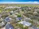 An aerial shot features a charming neighborhood with tree-lined streets and cozy homes under a bright blue sky at 418 Norwood Ct, Oviedo, FL 32765