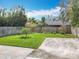 A large, green lawn features a fenced perimeter and a concrete pad in the corner of the yard at 418 Norwood Ct, Oviedo, FL 32765