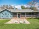 Backyard view featuring a patio, screened in porch, exterior architectural elements and lawn at 418 Norwood Ct, Oviedo, FL 32765