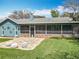 Backyard view featuring a patio, screened in porch, exterior architectural elements and lawn at 418 Norwood Ct, Oviedo, FL 32765