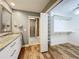 Bathroom featuring granite vanity, shower, and walk-in closet access at 418 Norwood Ct, Oviedo, FL 32765