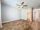 This bedroom features wood-look floors, a ceiling fan, and a closet at 418 Norwood Ct, Oviedo, FL 32765