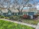 View of the home's facade highlighting the light blue siding, brick pathway, and manicured landscaping at 418 Norwood Ct, Oviedo, FL 32765