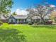 Charming single story home featuring well-manicured lawn, beautiful landscaping, and a lovely, traditional-style porch at 418 Norwood Ct, Oviedo, FL 32765