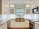 Bright kitchen featuring white cabinets, subway tile backsplash, and a stainless steel sink at 418 Norwood Ct, Oviedo, FL 32765