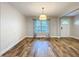 Open living space featuring hardwood floors, a decorative light fixture, and natural light that bathes the room at 418 Norwood Ct, Oviedo, FL 32765