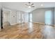 Spacious living room featuring vaulted ceiling, ceiling fan, and a double French door at 418 Norwood Ct, Oviedo, FL 32765