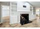 Living room with black marble fireplace and built-in cabinets and shelves at 418 Norwood Ct, Oviedo, FL 32765