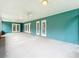 An enclosed patio with teal walls and four sets of glass doors at 418 Norwood Ct, Oviedo, FL 32765