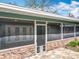 The screened in porch features a brick facade and access to the backyard at 418 Norwood Ct, Oviedo, FL 32765