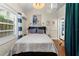 Cozy bedroom features hardwood floors, an accent wall, and plenty of natural light from the bright window at 421 Broadway Ave, Orlando, FL 32803