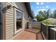 Exterior deck with wood railings and a view of the neighborhood and blue sky at 421 Broadway Ave, Orlando, FL 32803