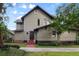 Inviting two-story home featuring neutral siding, brick accents, and a well-manicured lawn at 421 Broadway Ave, Orlando, FL 32803