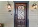 Close-up of an elegant front door with decorative glass and stylish exterior lighting at 421 Broadway Ave, Orlando, FL 32803