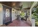 Cozy front porch featuring brick flooring, comfortable seating, and a decorative ceiling fan at 421 Broadway Ave, Orlando, FL 32803