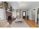 Cozy living room featuring a brick fireplace, neutral decor, and hardwood floors at 421 Broadway Ave, Orlando, FL 32803