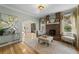 Cozy living room with a brick fireplace, hardwood floors, and plenty of natural light at 421 Broadway Ave, Orlando, FL 32803