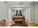 Stylish main bedroom featuring hardwood floors, neutral walls, and ample natural light at 421 Broadway Ave, Orlando, FL 32803