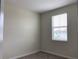 A cozy bedroom with neutral walls and carpet, brightened by a window at 4724 Tribute Trl, Kissimmee, FL 34746