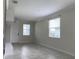 Bright living room with tile flooring, neutral paint, crown molding, and two large windows at 4724 Tribute Trl, Kissimmee, FL 34746