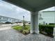 View of street from front porch of townhome with view of green lawns and uniform architecture at 4724 Tribute Trl, Kissimmee, FL 34746