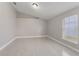 An empty bedroom with neutral paint, modern floor tile, a new window and ample natural light at 4909 Fiske Cir, Orlando, FL 32826