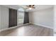 Bright bedroom featuring a ceiling fan, large window with curtains, and wood-look flooring at 4909 Fiske Cir, Orlando, FL 32826