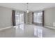 Light-filled dining area with modern lighting, gray drapes, neutral paint, and tile flooring at 4909 Fiske Cir, Orlando, FL 32826