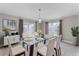 Modern dining area features glass table, plush seating, decorative plant and stylish wall art at 4909 Fiske Cir, Orlando, FL 32826