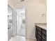 Bathroom featuring granite countertops, a view into the walk-in closet, and a bedroom visible through a doorway at 5025 Walker St, St Cloud, FL 34771