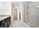 A primary bathroom featuring granite counters and a glass-enclosed shower at 5025 Walker St, St Cloud, FL 34771