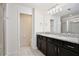 Bathroom with double sink vanity, granite countertops, and tiled floors at 5025 Walker St, St Cloud, FL 34771