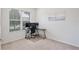 Bright bedroom featuring a modern desk setup and natural light from a large window at 5025 Walker St, St Cloud, FL 34771