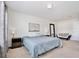 A spacious bedroom featuring a large bed and a stylish sofa at 5025 Walker St, St Cloud, FL 34771